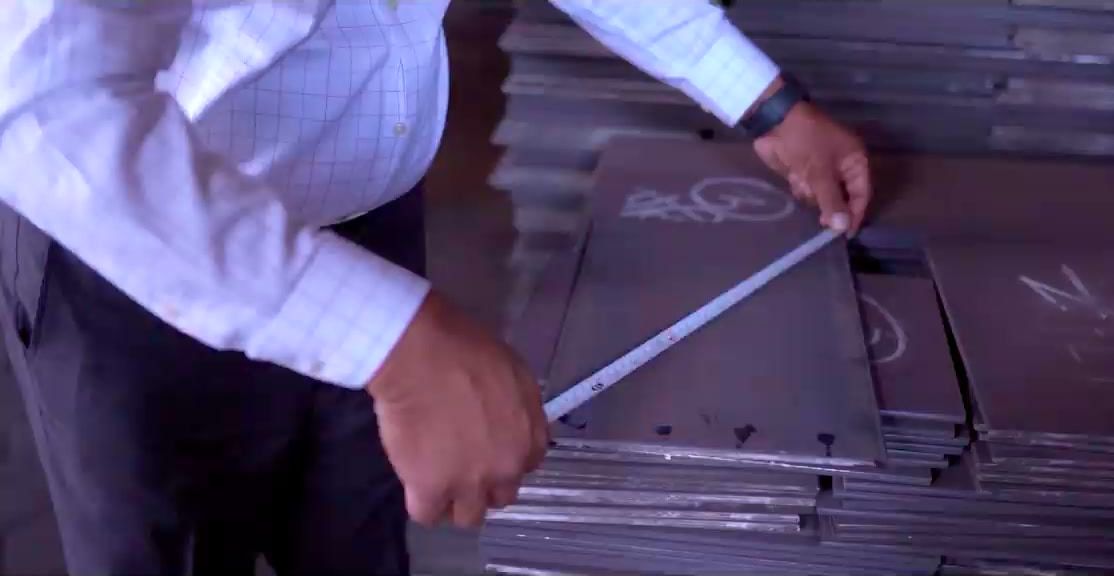 Measuring a stainless-steel sheet by hand