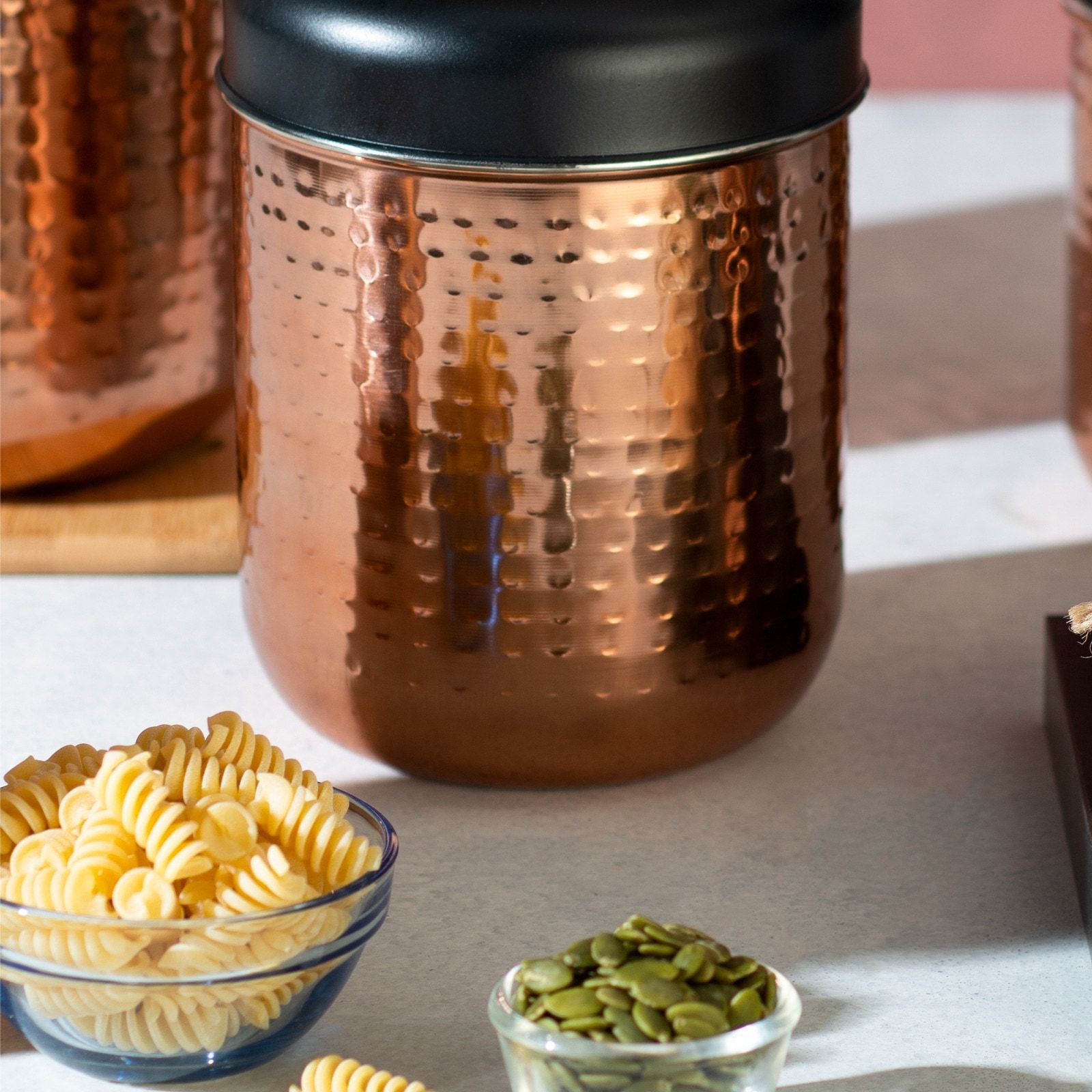 A hammered-copper Steelcraft canister with a black lid