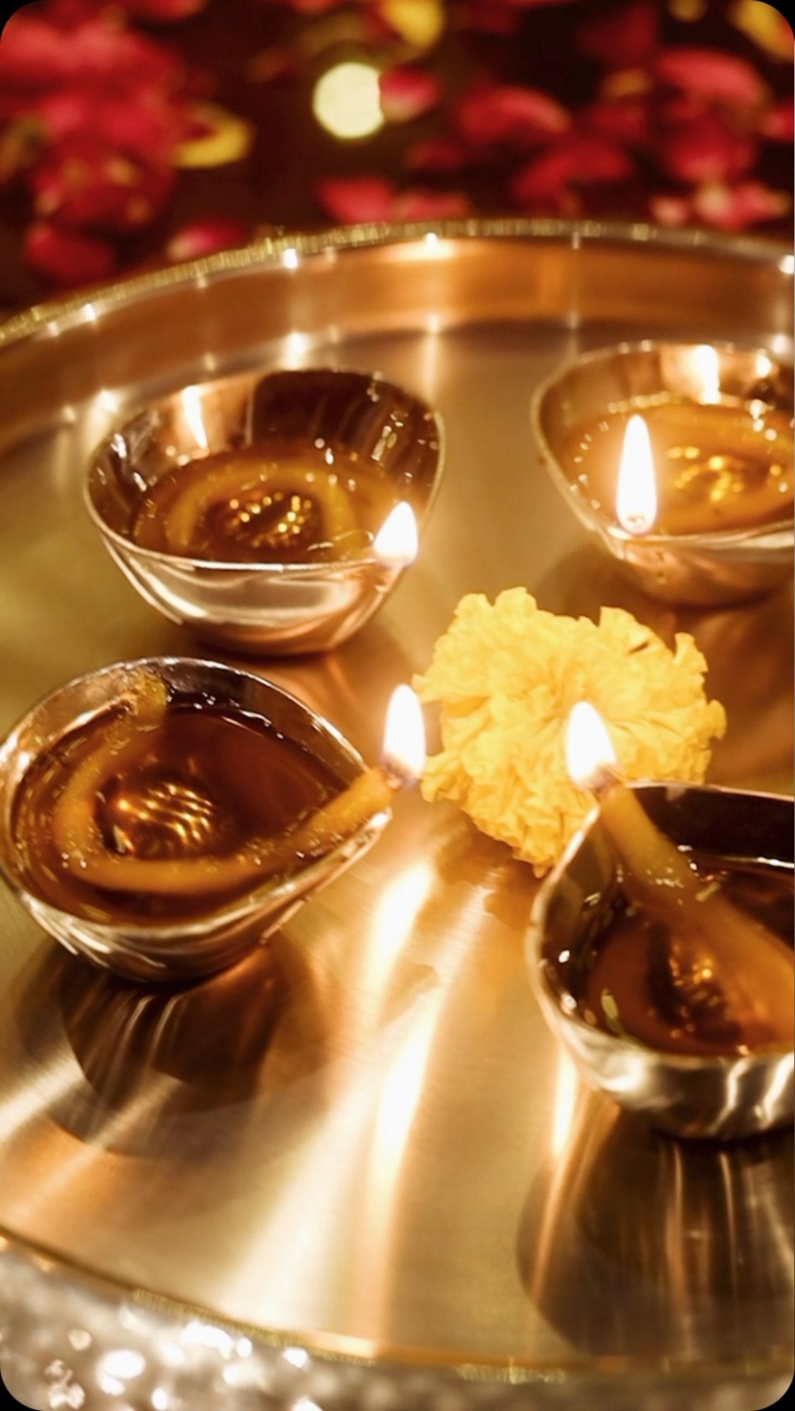 Diwali diyas burning on a mirror-steel platter